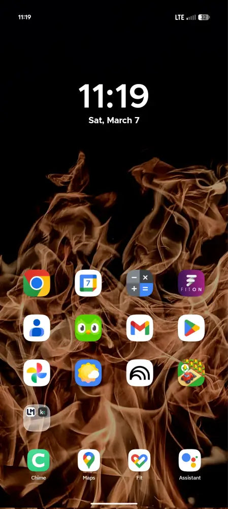 Phone screen with app icons on a dark background with flames