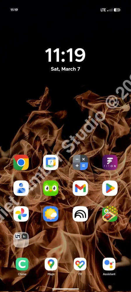 Phone screen with app icons on a dark background with flames